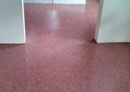 Industrial epoxy flooring being installed in apartment restrooms